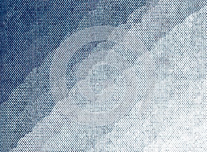 Blue halftone dot gradient on paper macro texture