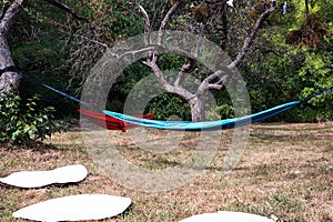 Blue hammock and red hammock, white circules on the grass. photo
