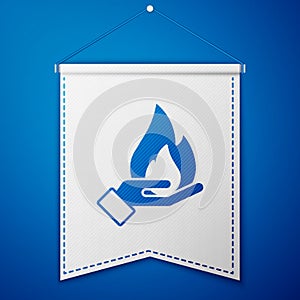 Blue Hand holding a fire icon isolated on blue background. Insurance concept. Security, safety, protection, protect
