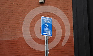 Blue handicap sign on the street - a symbol for mobility aid for people with disabilities