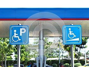 Blue handicapped parking sign at petrol station.