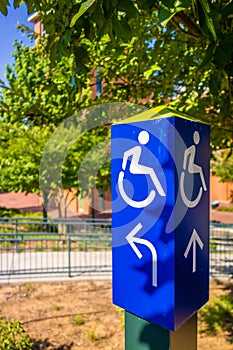 Blue handicapped wheel chair post sign