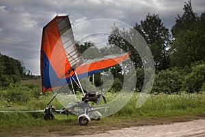 A blue hang-glider staying on a ground