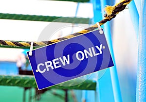 Blue hanging sign with Crew only words