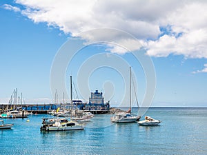 Blue harbormaster house and view over the beautiful sunny harbour of Marina del Sur in Las Galletas. Tenerife, Canary Islands, photo