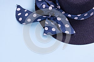 Blue hat with ribbon on blue background. Summer concept. Top view with copy space