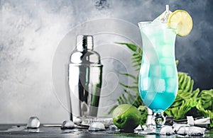 Blue Hawaii or Blue Lagoon - summer alcoholic cocktail with vodka, liqueur, tonic, pineapple juice and ice, in high Hurricane