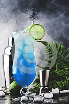 Blue Hawaiian or Blue Lagoon cocktail - summer alcoholic drink with vodka, liqueur, tonic, pineapple juice and ice. Copy space,