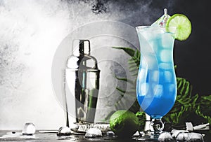 Blue Hawaiian or Blue Lagoon cocktail - summer alcoholic drink with vodka, liqueur, tonic, pineapple juice and ice. Copy space,