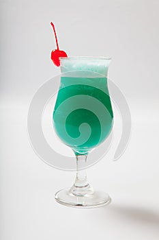 Blue Hawaiian cocktail with a cherry. White background