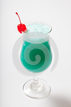 Blue Hawaiian cocktail with a cherry. White background