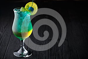 Blue hawaiian cocktail with mint on black background