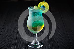 Blue hawaiian cocktail with mint on black background