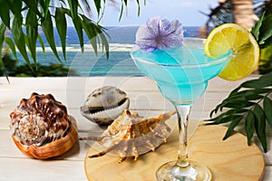 Blue Hawaiian cocktail on the tropical sea background