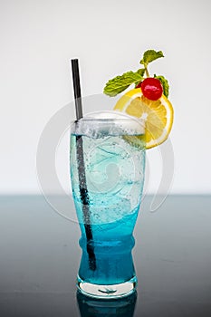 Blue Hawaiian Cocktails with lime and cherry decoration