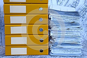 Blue heap of project drawings in yellow folder.