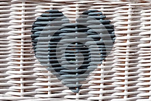 Blue heart painted on white wicker photo