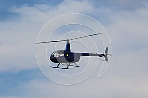 Blue Helicopter Flying through the Sky