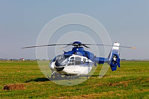 Blue helicopter on field