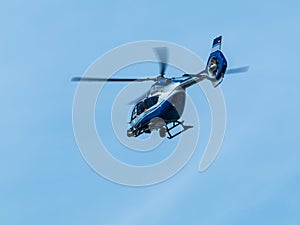 Blue helocopter in blue sky