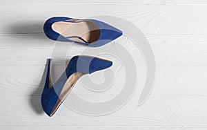 Blue high heels women shoes on white wooden background