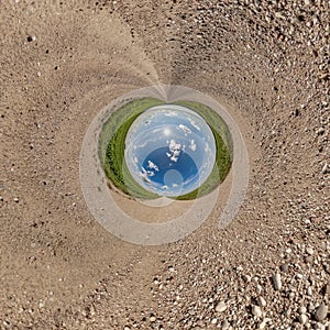 blue hole sphere little planet inside gravel sand round frame background