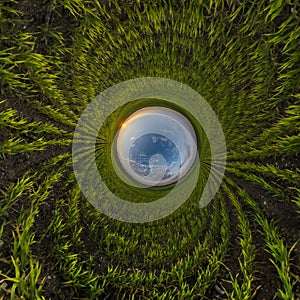 blue hole sphere little planet inside sand or dry grass round frame background