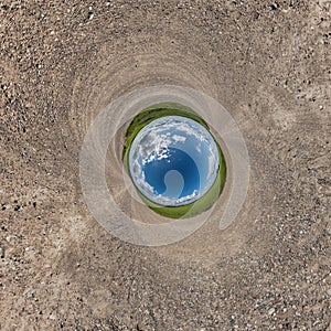 blue hole sphere little planet inside sand or dry grass round frame background