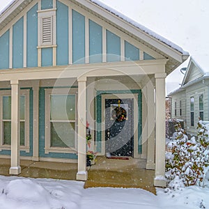 Blue home in Daybreak Utah with snow covered lawn