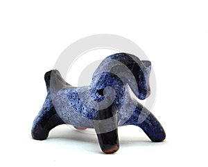 Blue horse, clay whistle from pouring ceramics isolated on a white background