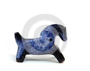 Blue horse, clay whistle from pouring ceramics isolated on a white background