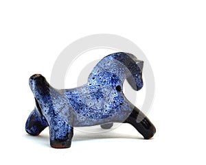 Blue horse, clay whistle from pouring ceramics isolated on a white background