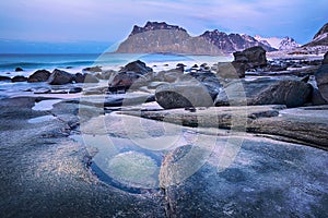 Blue hour. Beautiful Norway landscape of picturesque stones on the arctic beach of cold Norwegian Sea