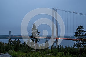 Blue hour picture of illuminated High Coast Bridge.