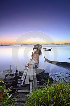 Blue hour scenery of old abandoned fisherman jetty before sunrise