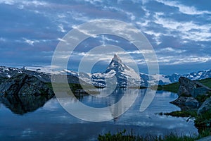 Blue hour shot of the Matterhorn Monte Cervino, Mont Cervin pyramid and Stellisee lake.