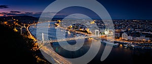 Blue hour shot. Panoramic look down from Gellert hill to castle hill, Danube river with parliament building, Elisabeth Bridge and