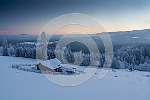 Blue hour in winter time in a remote mountain village Transylvania Romania