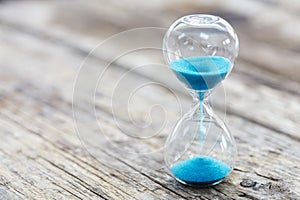 Blue hourglass background concept for deadline, urgency and countdown