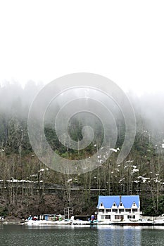 Blue house on coastline with fog in Rica, national park Abkhazia