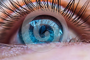 Blue human eye in a contact lens looking up close up. contact lens vision correction concept
