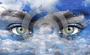 Blue human eyes with sky pattern