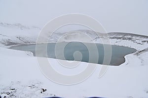 The blue Hverfjall Crater in spring with snow in background in Myvatn, Iceland