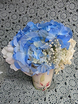 Blue Hydragea flower vase on lace