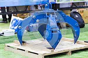 The blue hydraulic manipulator  for loading steel scrap metal