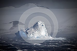 Blue ice berg in stormy seas, Antarctic Sound