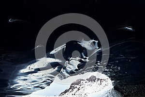 Blue ice cave arch and rocky mountains