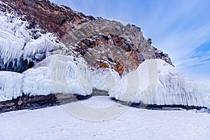 Blue ice cave grotto lake Baikal Olkhon island, Russia. Frozen clear icicles, beautiful winter landscape