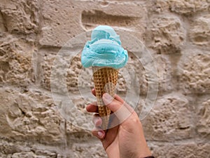 Blue ice-cream against stone wall