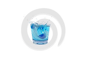 Blue ice cubes splashing into glass of water